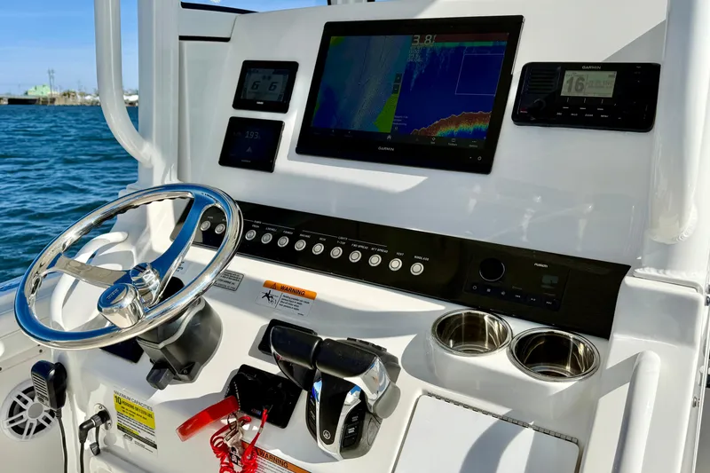 Slide: The Image of Helm of 2022 Regulator 23 boat with navigation screens and controls. - 21