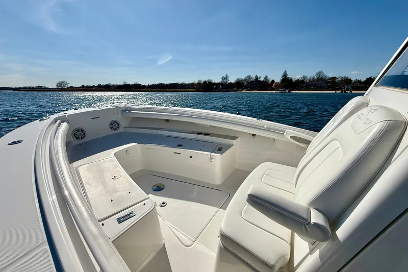 Slide: The Image of 2022 Regulator 23 boat interior with white seating on a sunny day. - 23