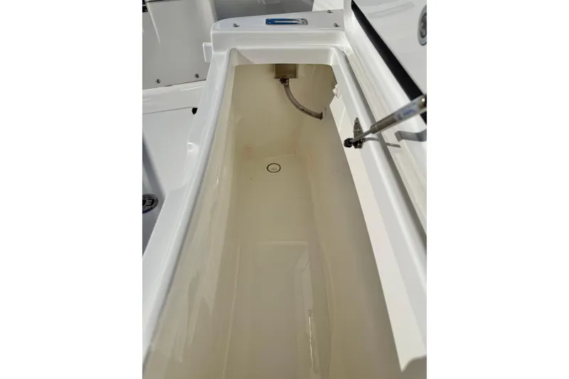 Slide: The Image of Open storage compartment on a 2022 Regulator 23 boat, showcasing interior space. - 28