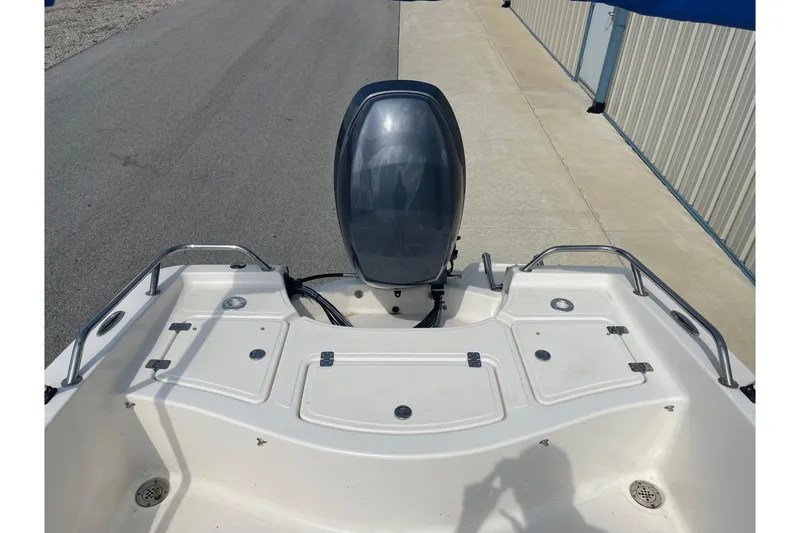 Slide: The Image of 2013 Pioneer 175 Venture boat with outboard motor, docked on a concrete surface. - 11