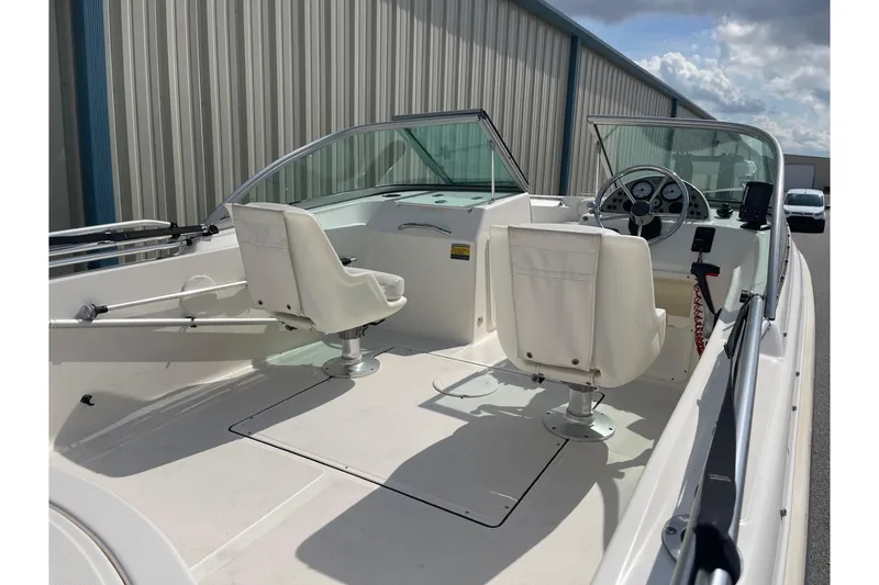 Slide: The Image of 2013 Pioneer 175 Venture boat interior with white seating and steering console. - 13
