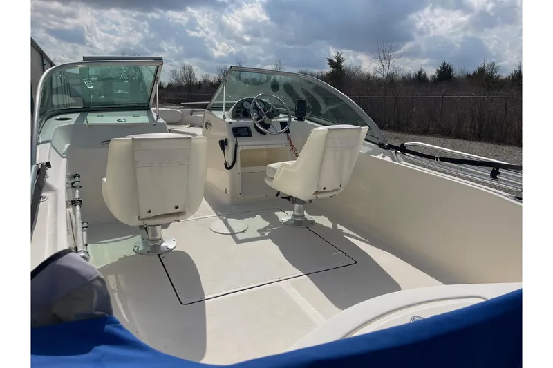 Slide: The Image of 2013 Pioneer 175 Venture boat interior with dual white seats and steering console. - 14