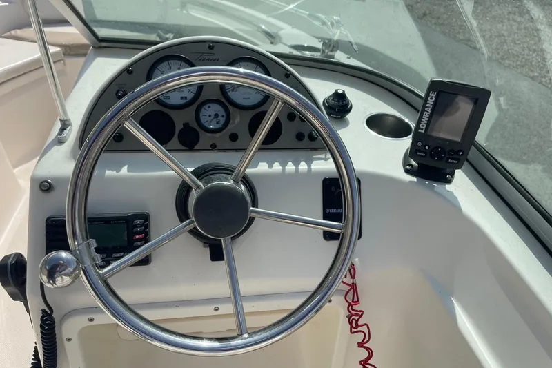 Slide: The Image of Steering console of a 2013 Pioneer 175 Venture boat with gauges and navigation equipment. - 18