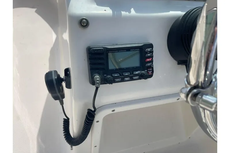 Slide: The Image of VHF radio on 2013 Pioneer 175 Venture boat dashboard, featuring communication controls. - 20