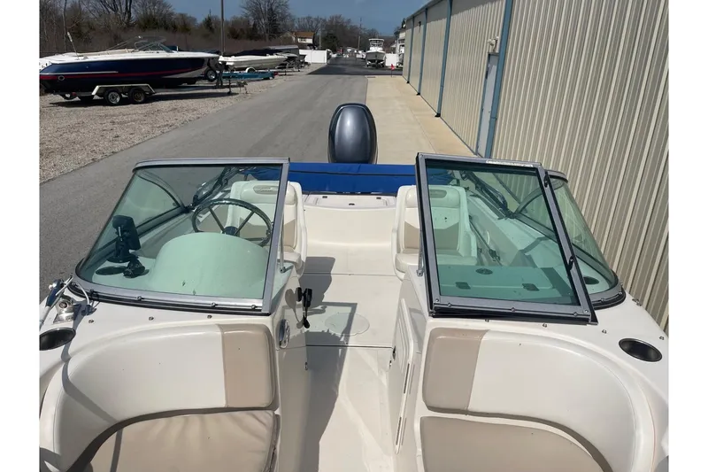 Slide: The Image of 2013 Pioneer 175 Venture boat with dual windshields, parked near other boats. - 27