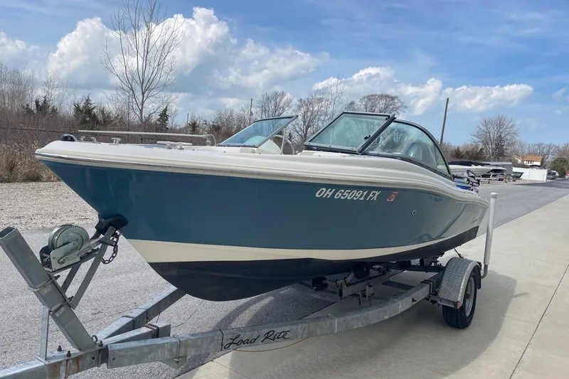 Slide: The Image of 2013 Pioneer 175 Venture boat on trailer, parked outdoors under a blue sky. - 3
