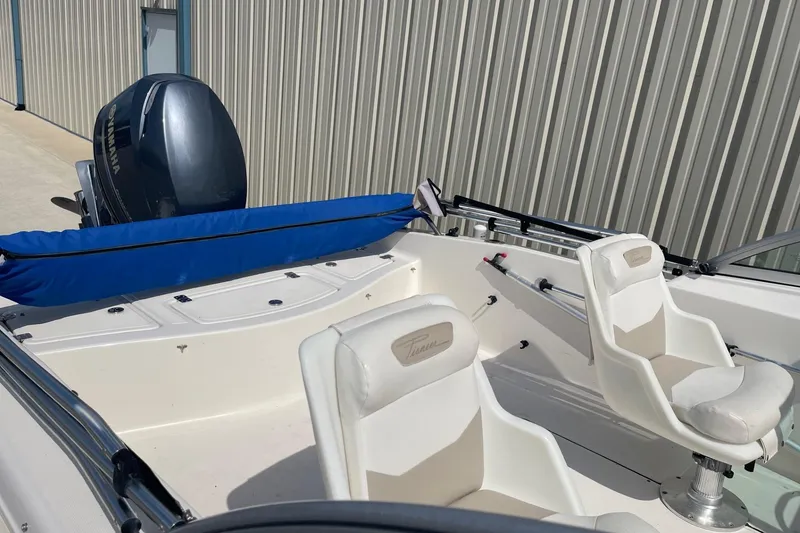 Slide: The Image of 2013 Pioneer 175 Venture boat interior with Yamaha outboard motor, featuring white seating and blue cover. - 8