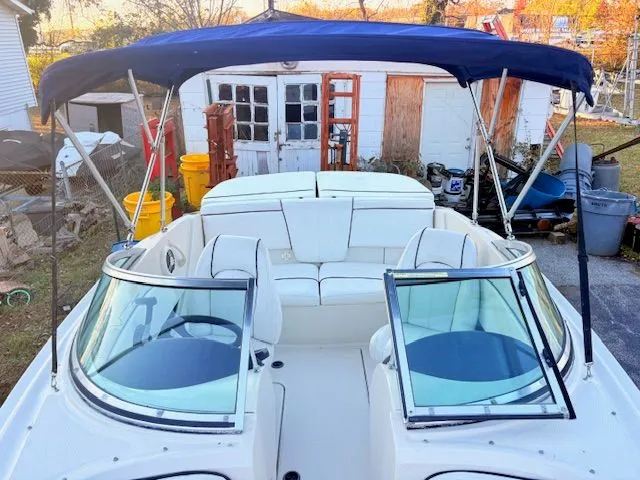 Slide: The Image of 2007 Sea Ray 185 boat with blue canopy parked outdoors. - 12