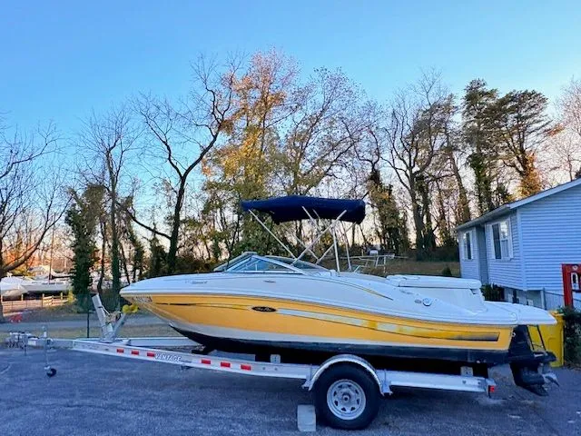 Slide: The Image of Yellow 2007 Sea Ray 185 boat on trailer, parked outdoors. - 3