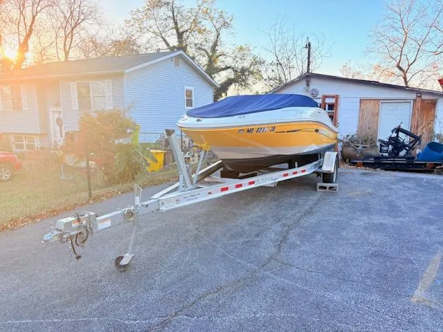 Slide: The Image of Yellow 2007 Sea Ray 185 boat on trailer in front of house. - 4