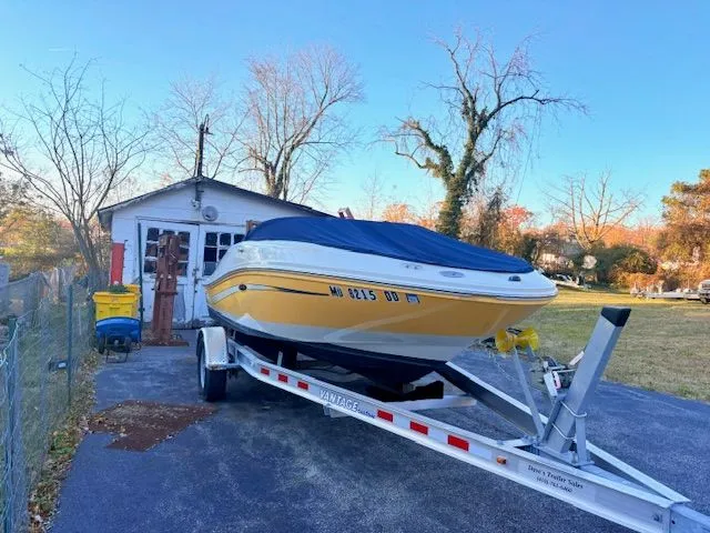 Slide: The Image of 2007 Sea Ray 185 boat on trailer in front of garage. - 6