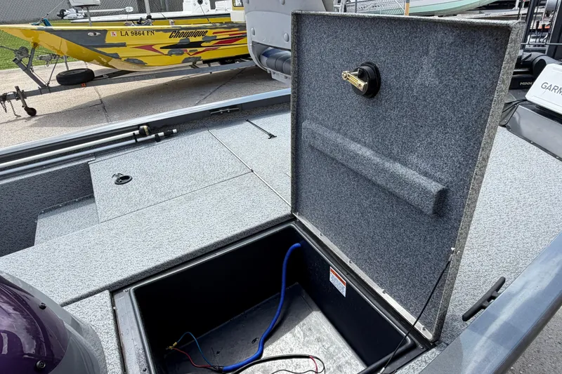 Slide: The Image of Open storage compartment on a 2022 G3 Sportsman 1710 boat, with visible wiring. - 10