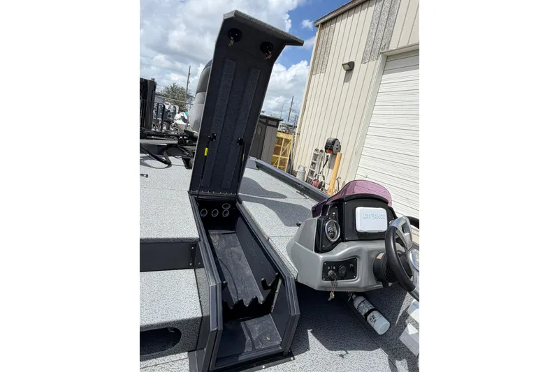 Slide: The Image of 2022 G3 Sportsman 1710 boat with open storage compartment and steering console. - 11