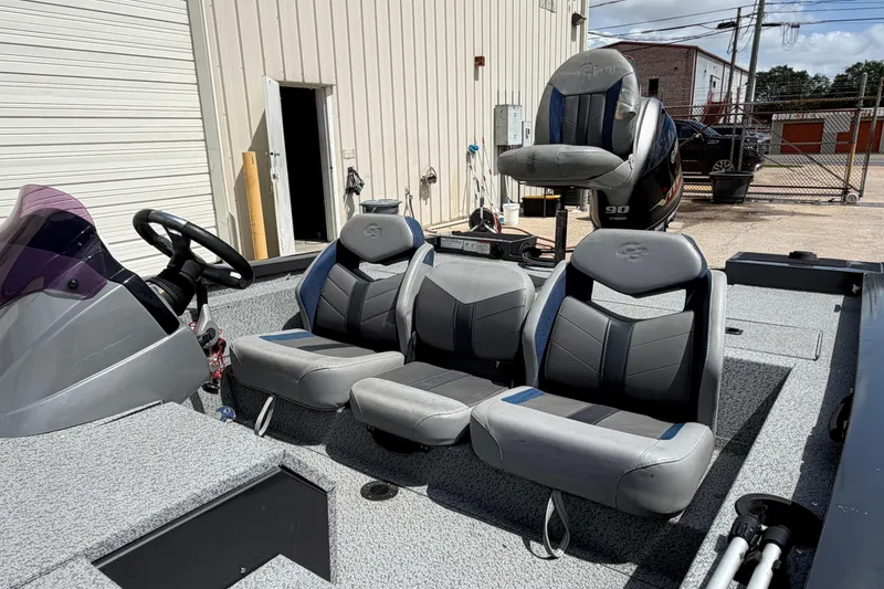 Slide: The Image of 2022 G3 Sportsman 1710 boat interior with gray seating and steering wheel. - 12