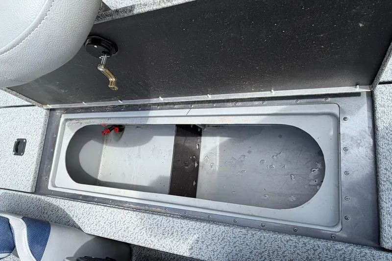 Slide: The Image of Open storage compartment in 2022 G3 Sportsman 1710 boat, featuring a secure latch. - 14