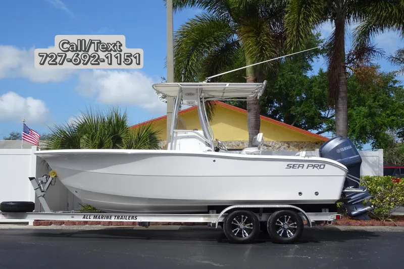 The Image of 2005 Sea Pro 206 Center Console boat on trailer, palm trees in background. - 0
