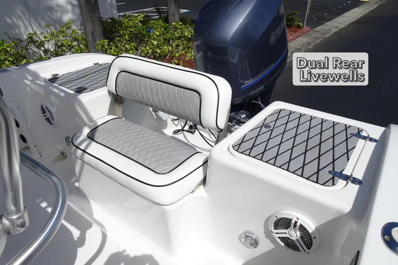 Slide: The Image of 2005 Sea Pro 206 Center Console boat with dual rear livewells and cushioned seating. - 11