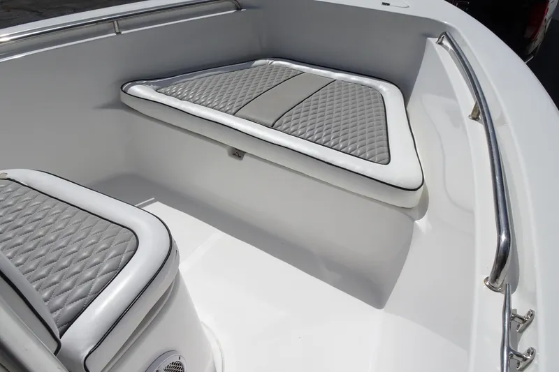 Slide: The Image of 2005 Sea Pro 206 Center Console boat interior with cushioned seating and stainless steel railing. - 13