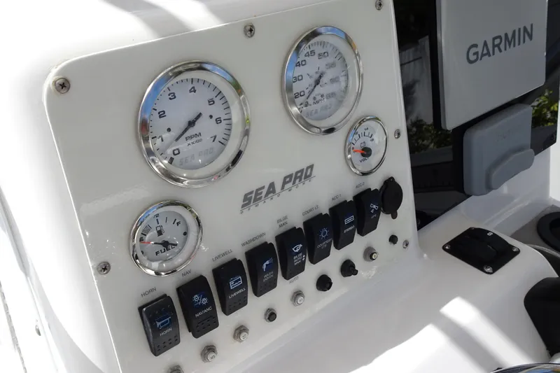 Slide: The Image of Dashboard of a 2005 Sea Pro 206 Center Console boat with gauges and switches. - 16