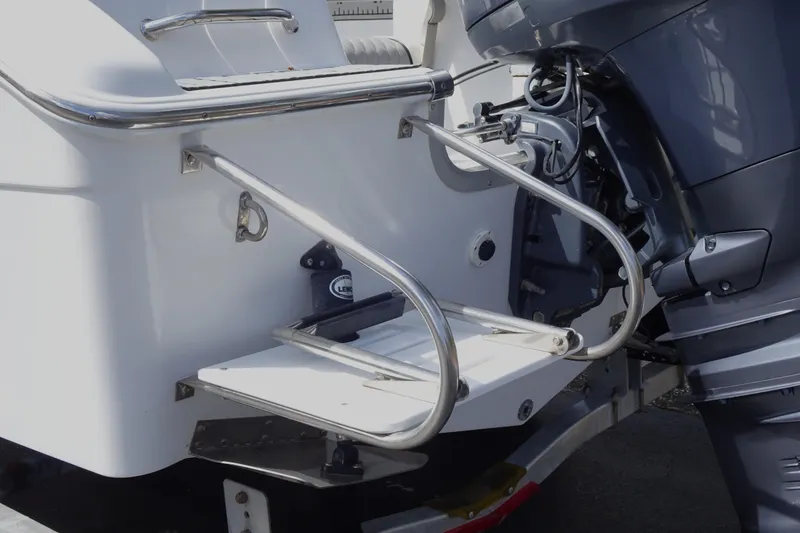 Slide: The Image of 2005 Sea Pro 206 Center Console boat with stainless steel swim platform and outboard motor. - 18