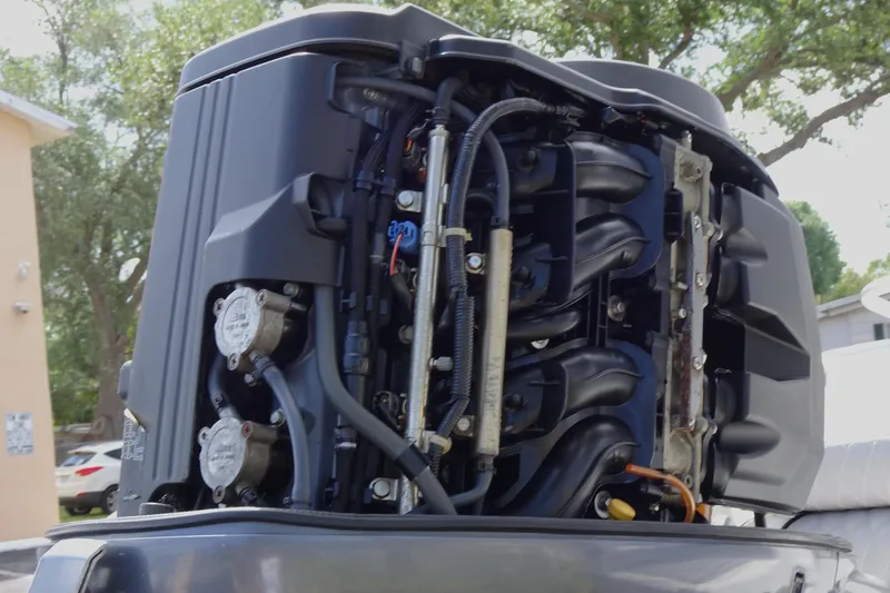 Slide: The Image of Close-up of a 2005 Sea Pro 206 Center Console boat engine, showcasing intricate components. - 19