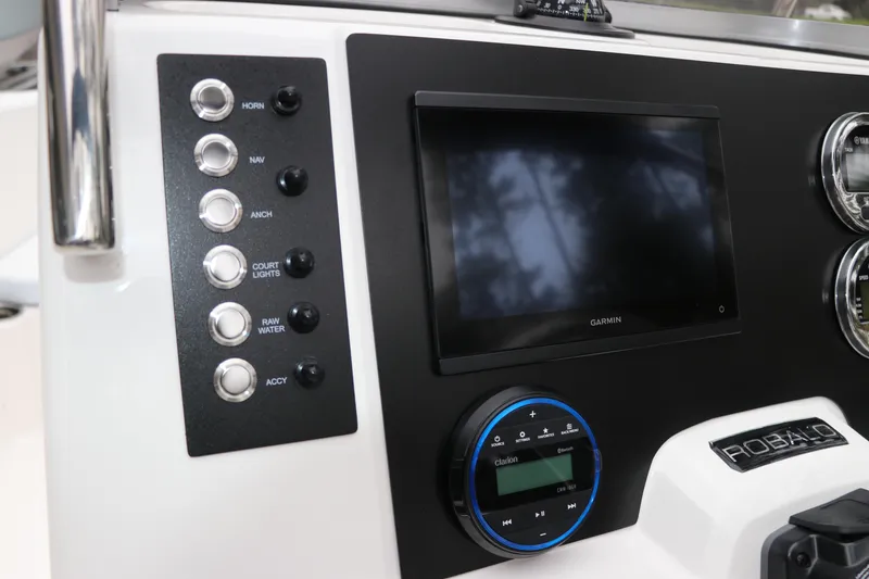 Slide: The Image of 2026 Robalo R180 Center Console dashboard with Garmin display and control panel. - 22