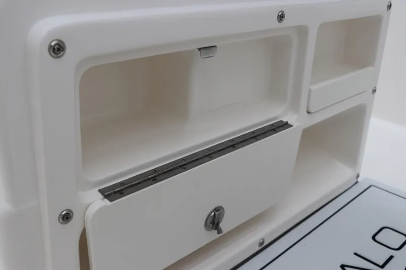 Slide: The Image of 2026 Robalo R180 Center Console storage compartment detail. - 27