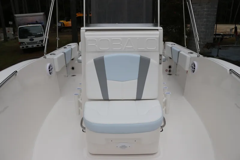 Slide: The Image of 2026 Robalo R180 Center Console boat interior with cushioned seating and cup holders. - 32