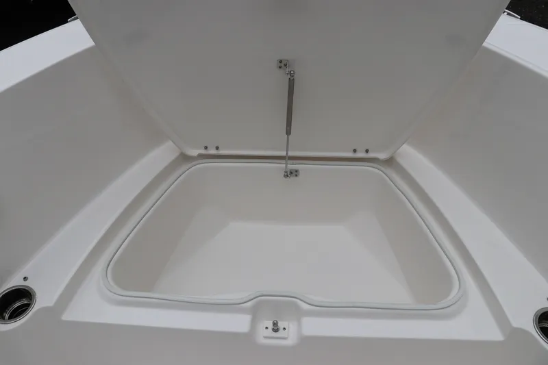 Slide: The Image of 2026 Robalo R180 Center Console storage compartment, open lid, spacious interior. - 37