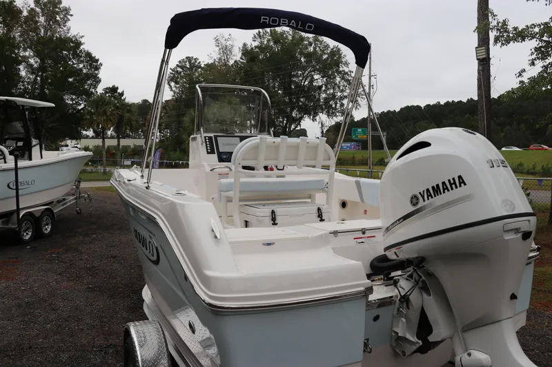 Slide: The Image of 2026 Robalo R180 Center Console boat with Yamaha engine, parked outdoors. - 4