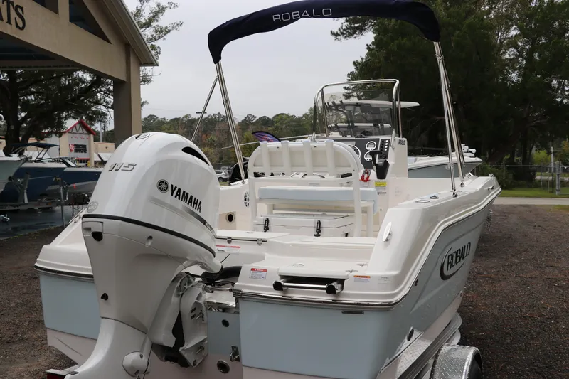 Slide: The Image of 2026 Robalo R180 Center Console boat with Yamaha engine, parked outdoors. - 6