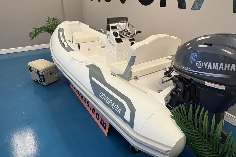 Slide: The Image of 2026 Novurania DL 360 boat with Yamaha engine on display indoors. - 3