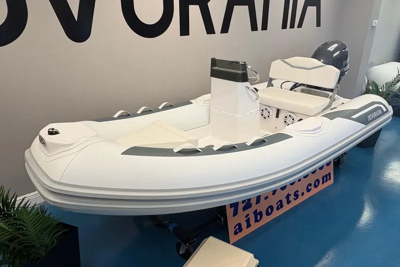 Slide: The Image of 2026 Novurania DL 360 inflatable boat displayed indoors, featuring sleek design and modern seating. - 4
