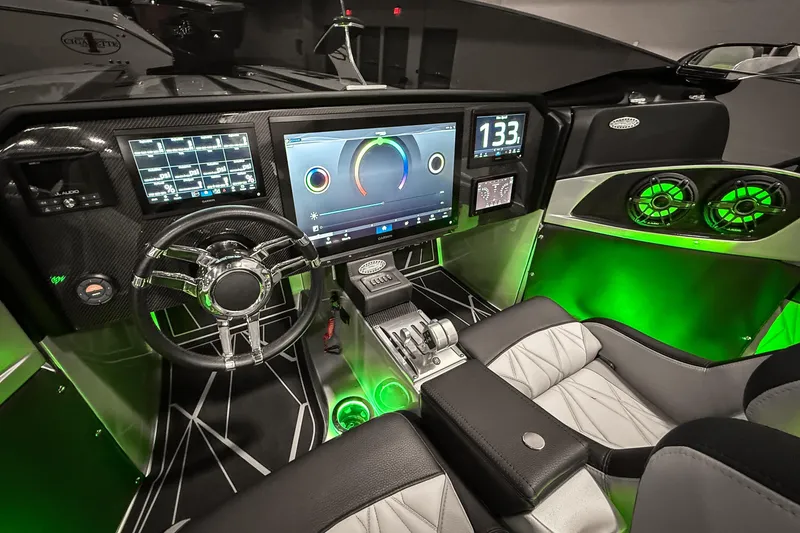 Slide: The Image of 2027 Nor-Tech 4000 Roadster cockpit with advanced digital dashboard and green ambient lighting. - 11