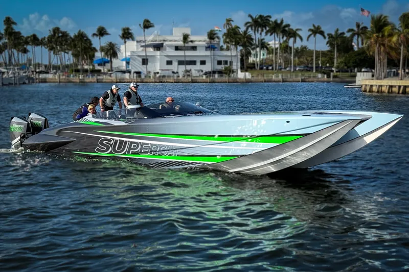 Slide: The Image of 2027 Nor-Tech 4000 Roadster powerboat with vibrant green accents on the water. - 5