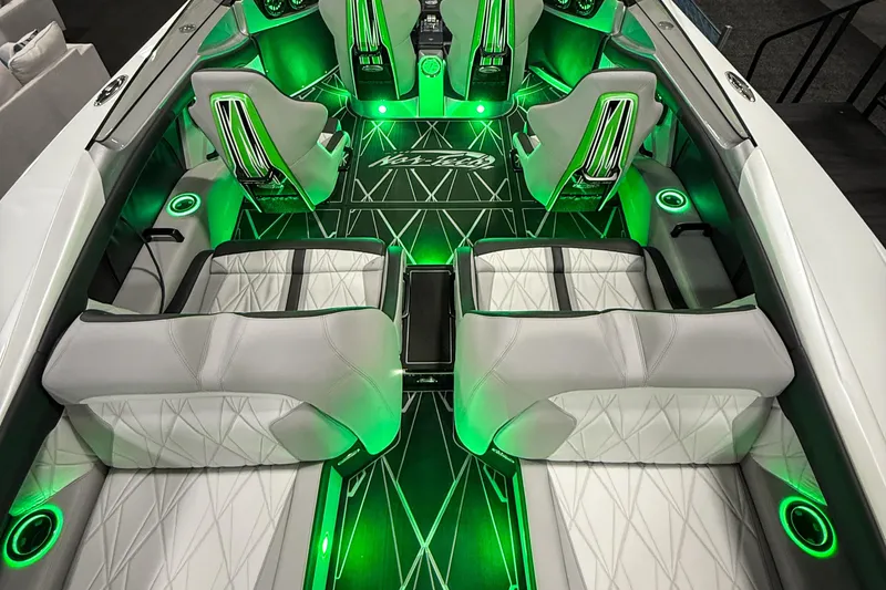 Slide: The Image of Luxurious 2027 Nor-Tech 4000 Roadster interior with green LED lighting and stylish seating. - 8