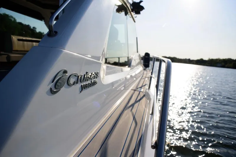 Slide: The Image of 2012 Cruisers Yachts 48 Cantius on water, showcasing sleek design and branding. - 11