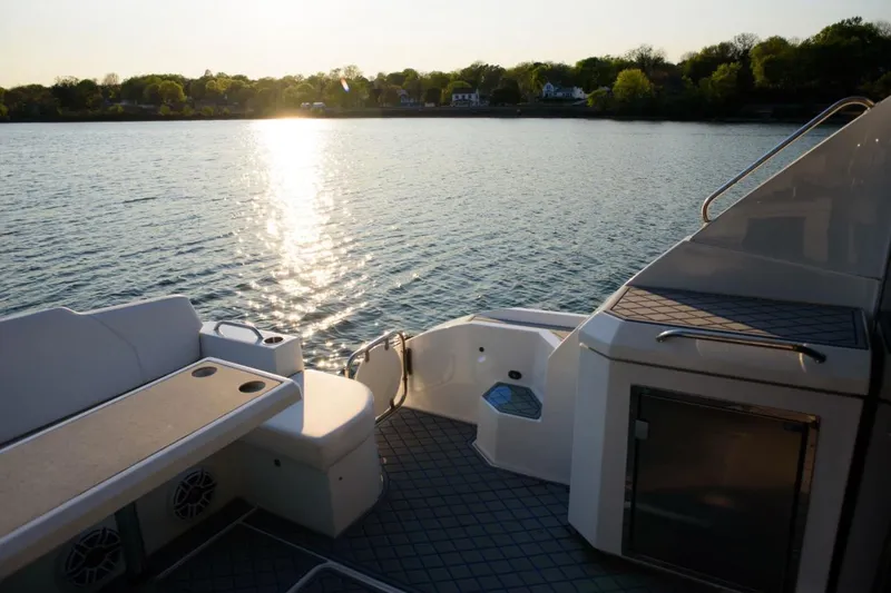 Slide: The Image of 2012 Cruisers Yachts 48 Cantius deck overlooking serene lake at sunset. - 14