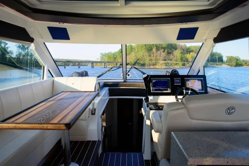 Slide: The Image of Interior view of 2012 Cruisers Yachts 48 Cantius with navigation screens and seating. - 20