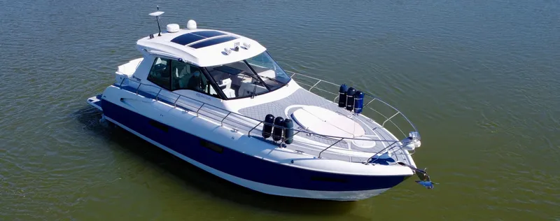 Slide: The Image of 2012 Cruisers Yachts 48 Cantius on calm water, showcasing sleek design and luxury features. - 4