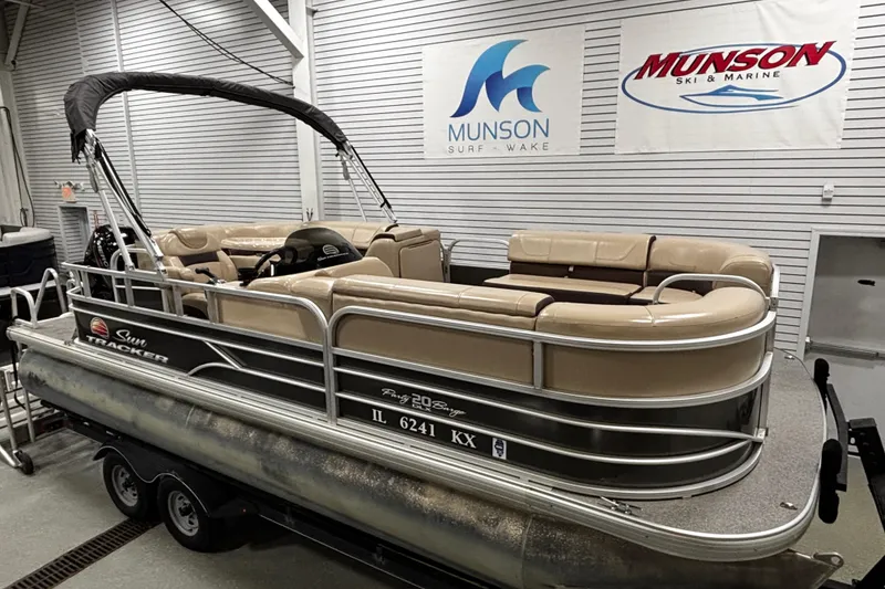 The Image of 2018 Sun Tracker Party Barge 20 DLX pontoon boat in showroom with beige seating. - 0