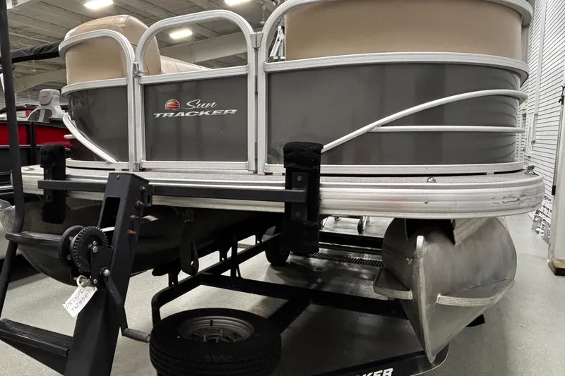 Slide: The Image of 2018 Sun Tracker Party Barge 20 DLX pontoon boat on trailer in showroom. - 10