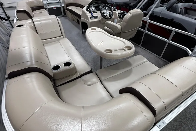 Slide: The Image of 2018 Sun Tracker Party Barge 20 DLX interior with plush seating and steering console. - 16