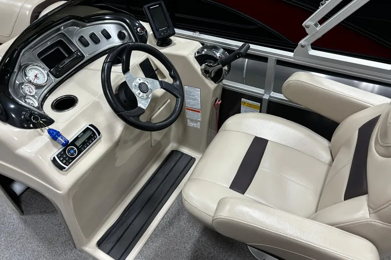 Slide: The Image of 2018 Sun Tracker Party Barge 20 DLX helm with steering wheel and control panel. - 2