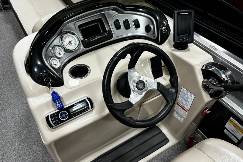 Slide: The Image of 2018 Sun Tracker Party Barge 20 DLX dashboard with steering wheel and control panel. - 21