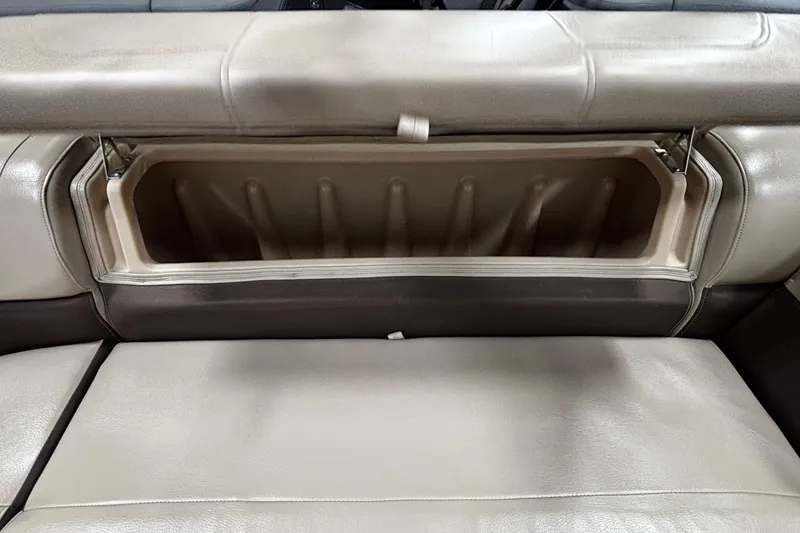 Slide: The Image of 2018 Sun Tracker Party Barge 20 DLX storage compartment with open seat cushion. - 23