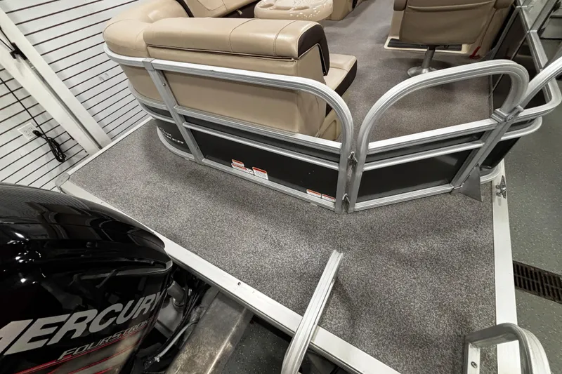 Slide: The Image of 2018 Sun Tracker Party Barge 20 DLX interior with Mercury FourStroke engine visible. - 25