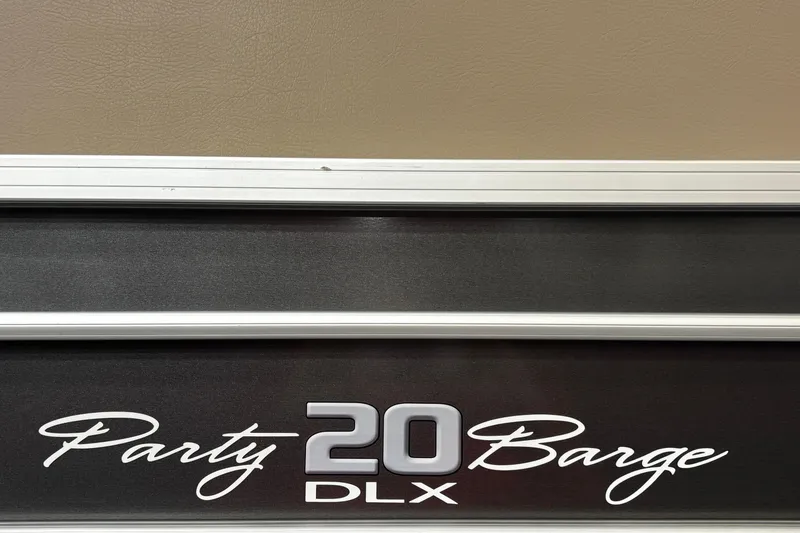 Slide: The Image of 2018 Sun Tracker Party Barge 20 DLX logo on boat exterior. - 26