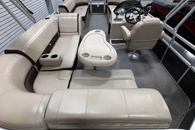 Slide: The Image of 2018 Sun Tracker Party Barge 20 DLX interior with plush seating and steering console. - 4