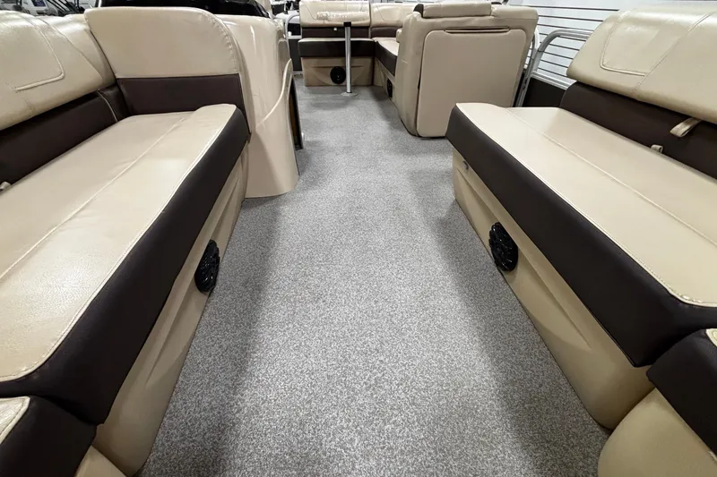Slide: The Image of 2018 Sun Tracker Party Barge 20 DLX interior with beige seating and carpeted floor. - 5